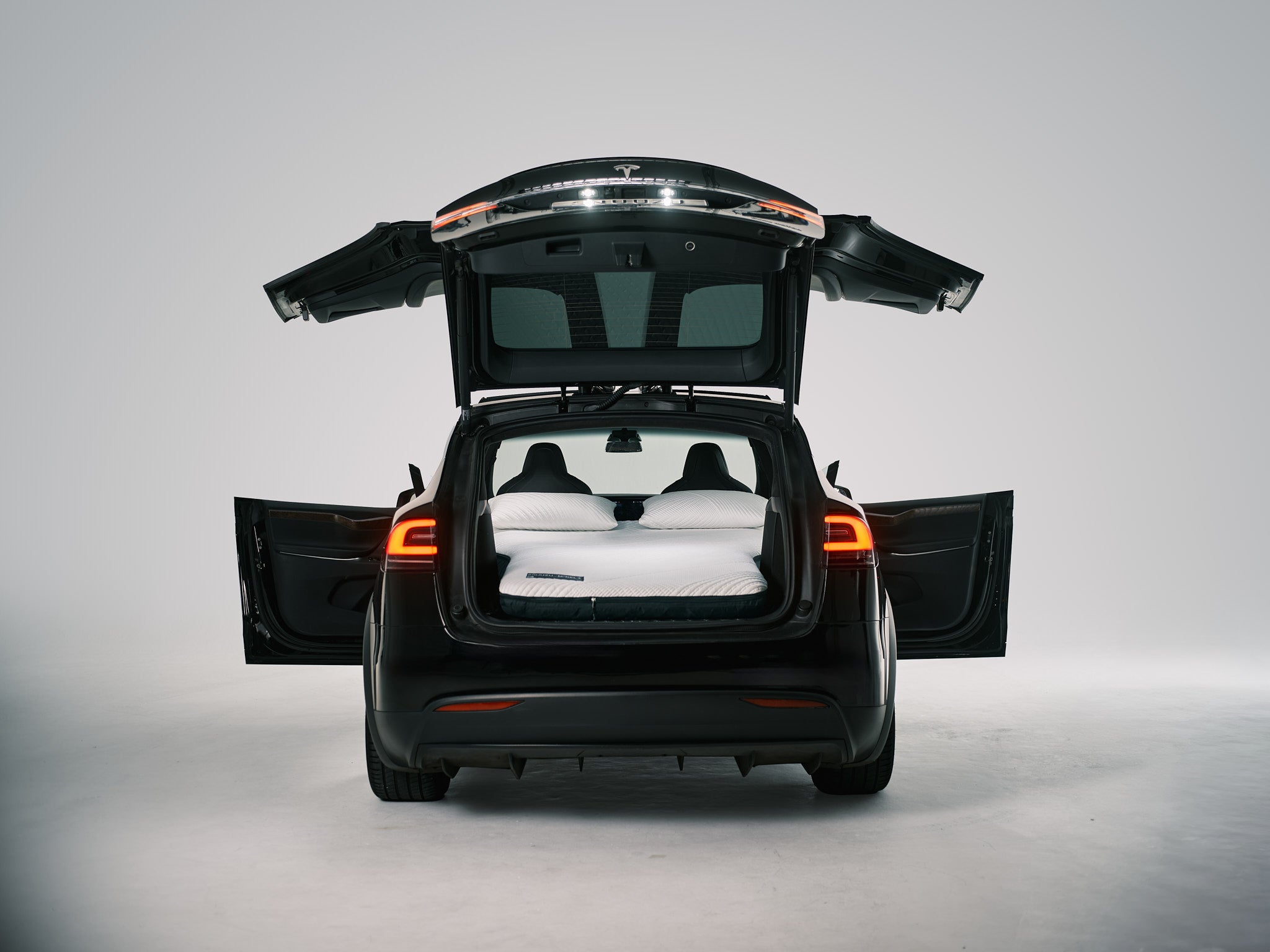 Snuuzu Tesla Model X car mattress shown fully set up for sleeping, designed for perfect fit and comfort during road trips and camping.