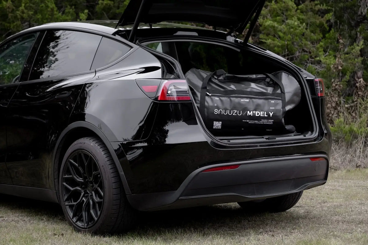 Packed Snuuzu Model Y mattress bag in the open rear hatch