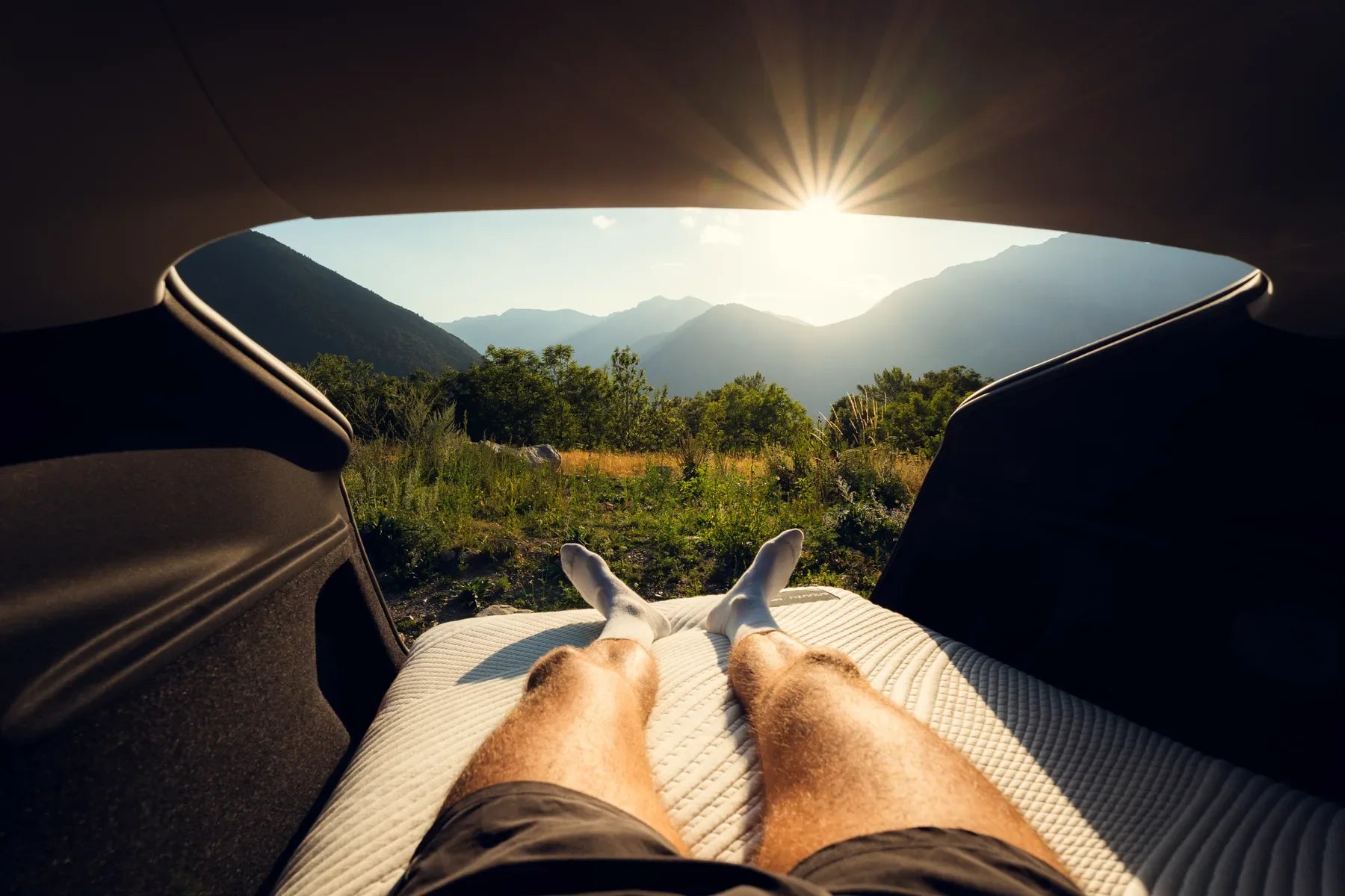View from a Snuuzu mattress through the open hatch of a Tesla Model Y