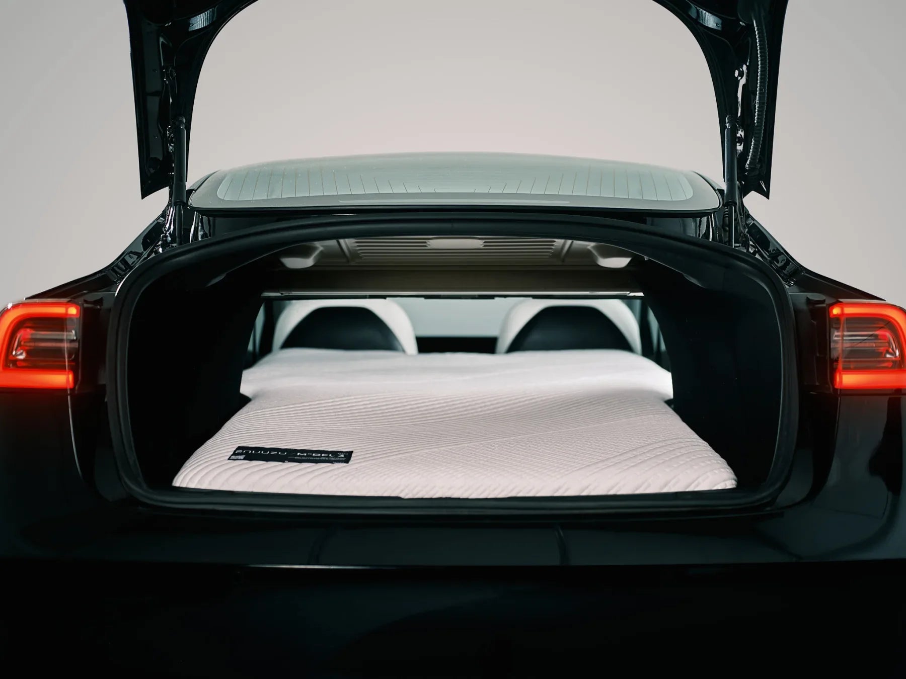 Snuuzu mattress installed inside the trunk opening of a Tesla Model 3