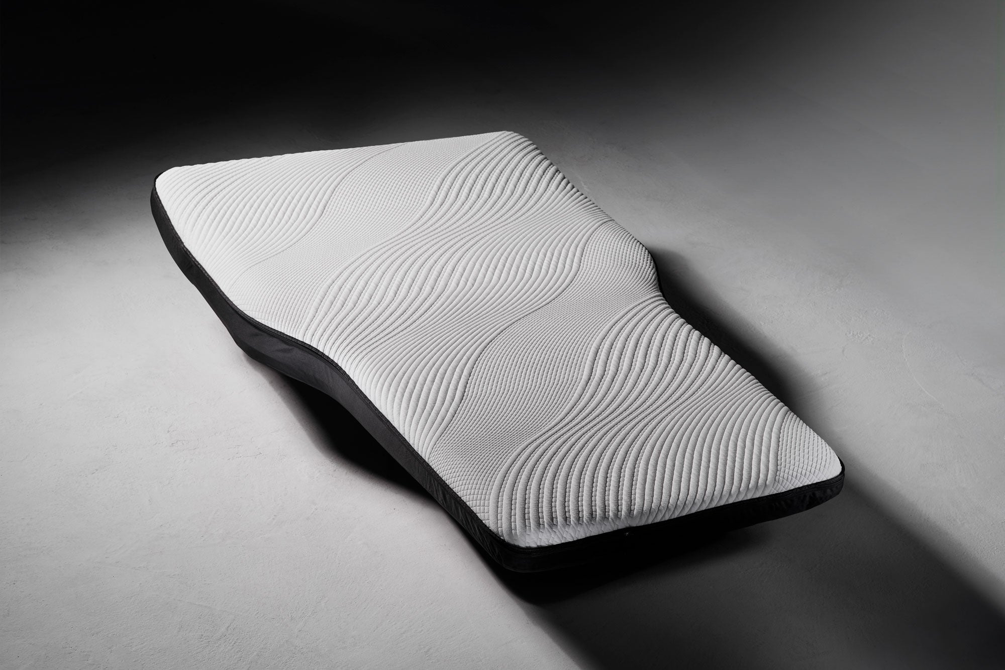 3d Model of the Snuuzu Tesla Mattress, shown in dramatic lighting. 