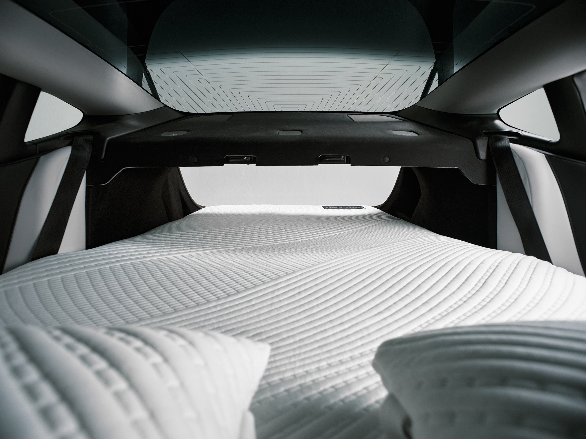 Snuuzu Tesla Model 3 camping mattress installed inside the trunk showing spacious headroom and panoramic glass roof