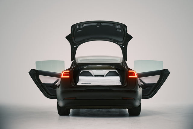 Snuuzu Tesla Model 3 car camping mattress fully installed with rear trunk open showing complete sleeping setup