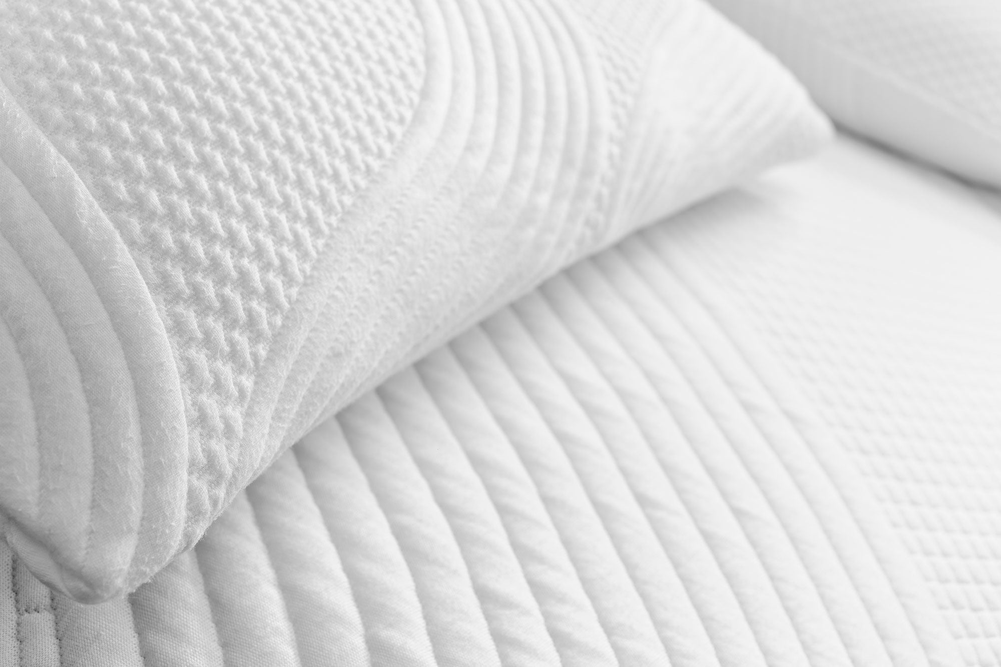 Close-up of Snuuzu Tesla camping mattress and pillow in organic Lyocell Tencel fabric showing premium quilted detailing